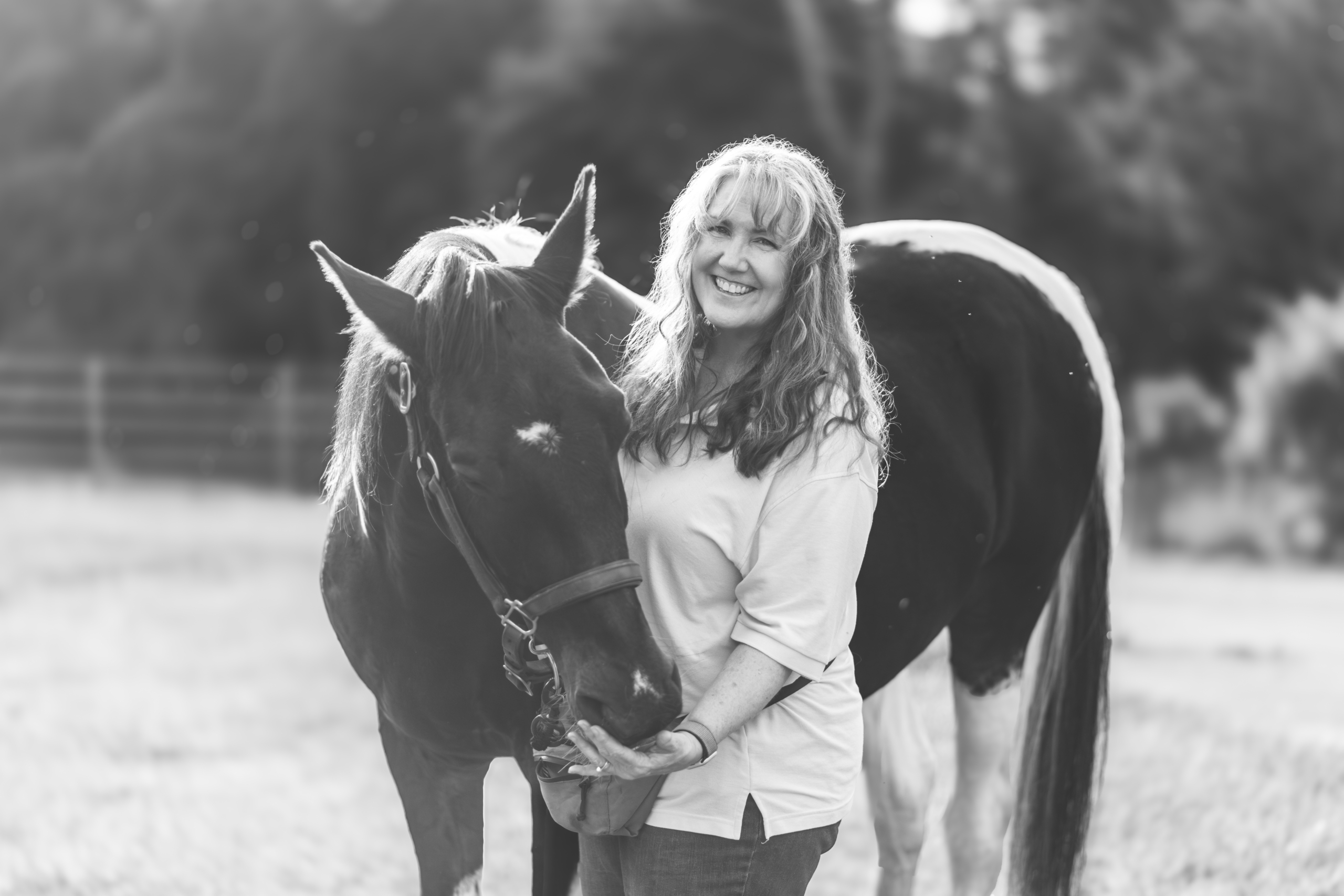 A black and white picture of Lisa Turcotte and her Saddlebred Forest.